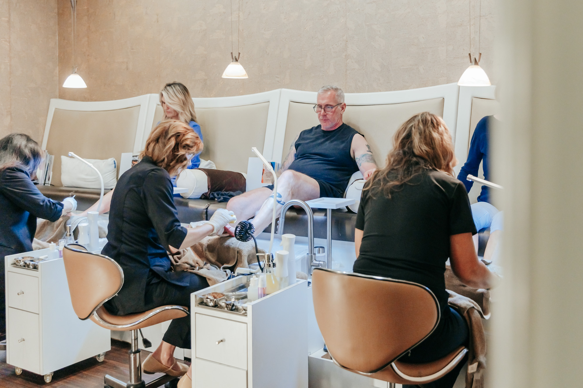 Modern nail salon interior with pedicure chairs and lounge seating